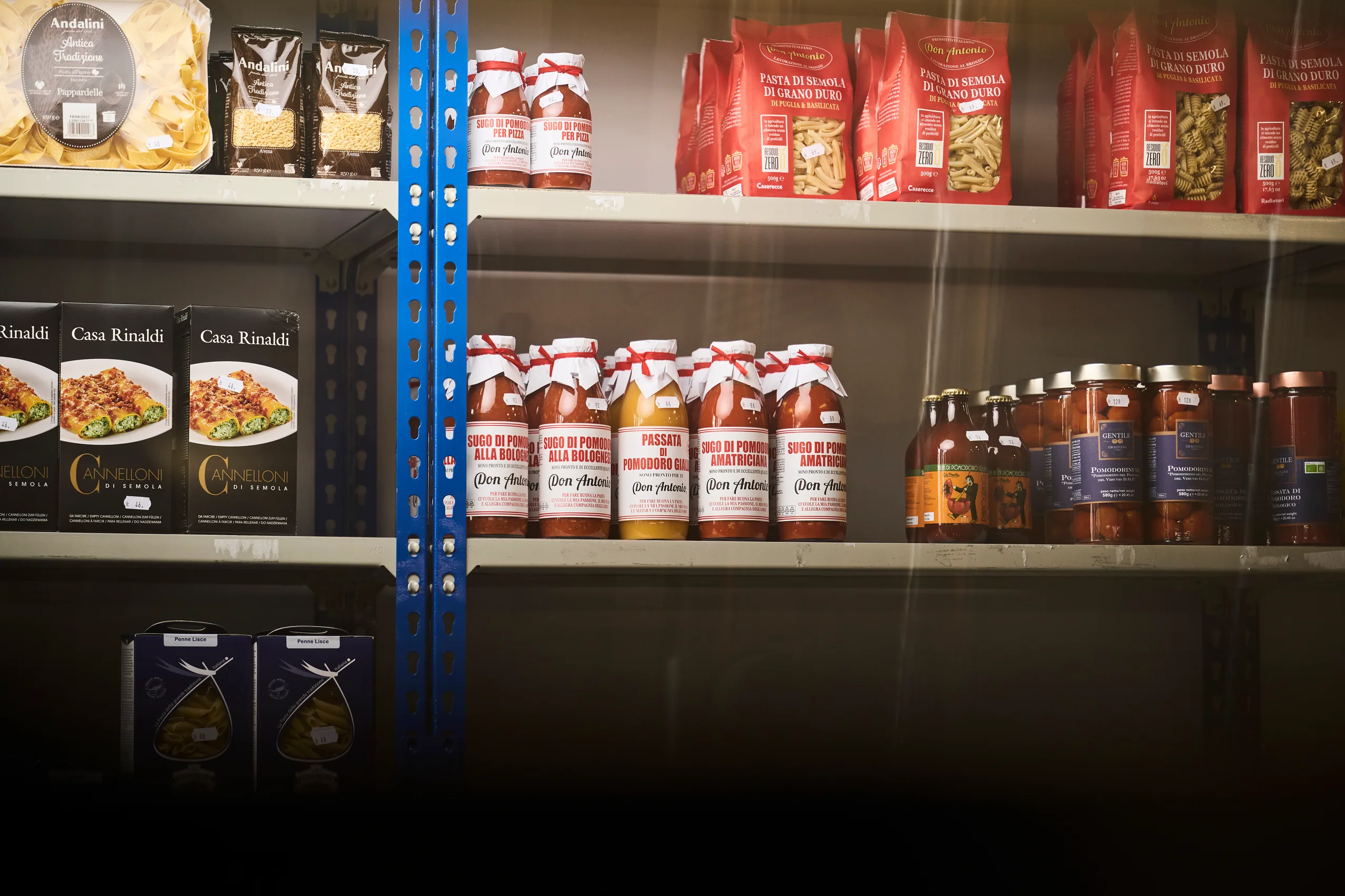 Hyller med italiensk pasta, sugo og andre importerte råvarer